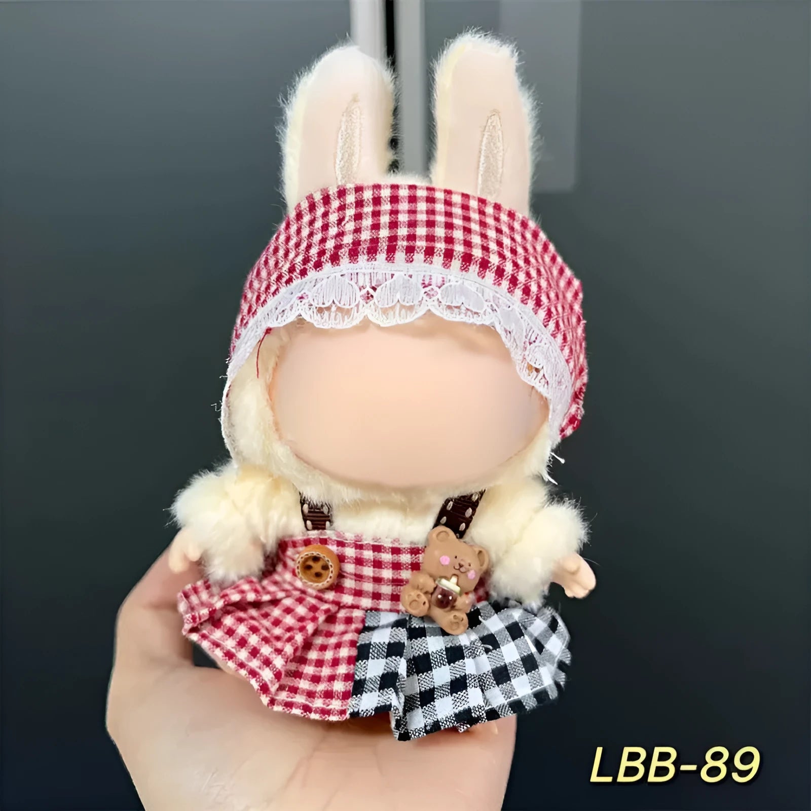 Plastic doll clothing costume for 17cm tall vinyl figurines on a display stand.