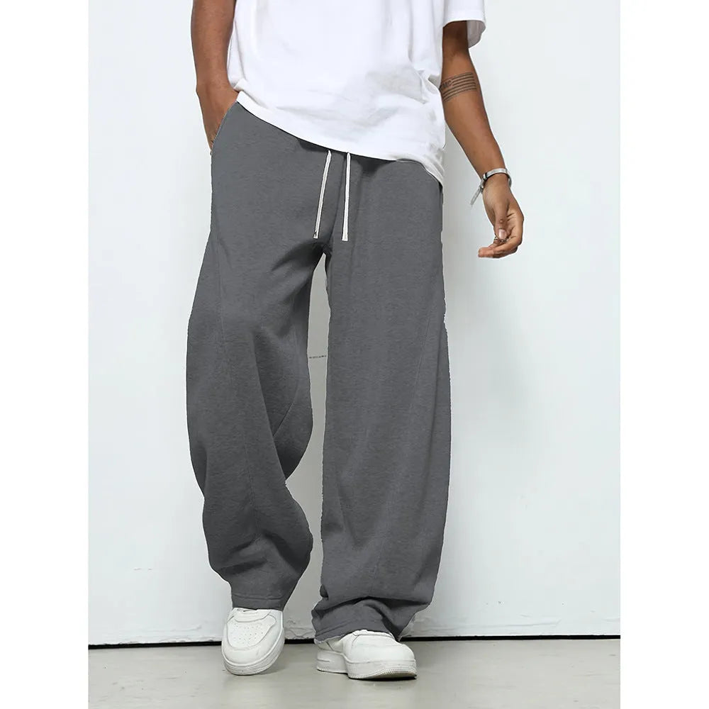 Men's solid-colour casual trousers with a drawstring waist in a straight-leg style.