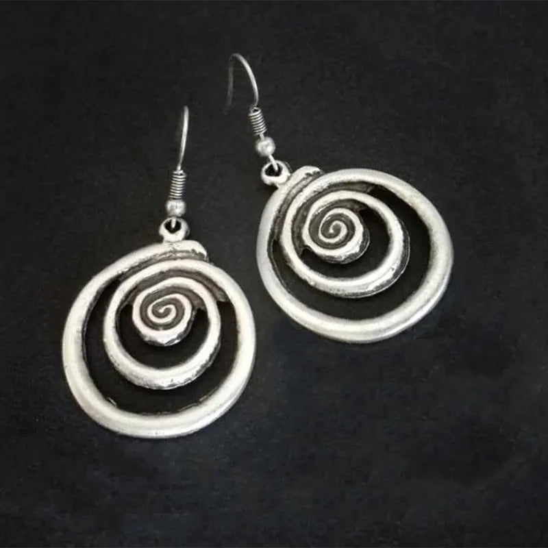 Geometric spiral distressed silver earrings measuring 2.6cm by 5cm with unisex design