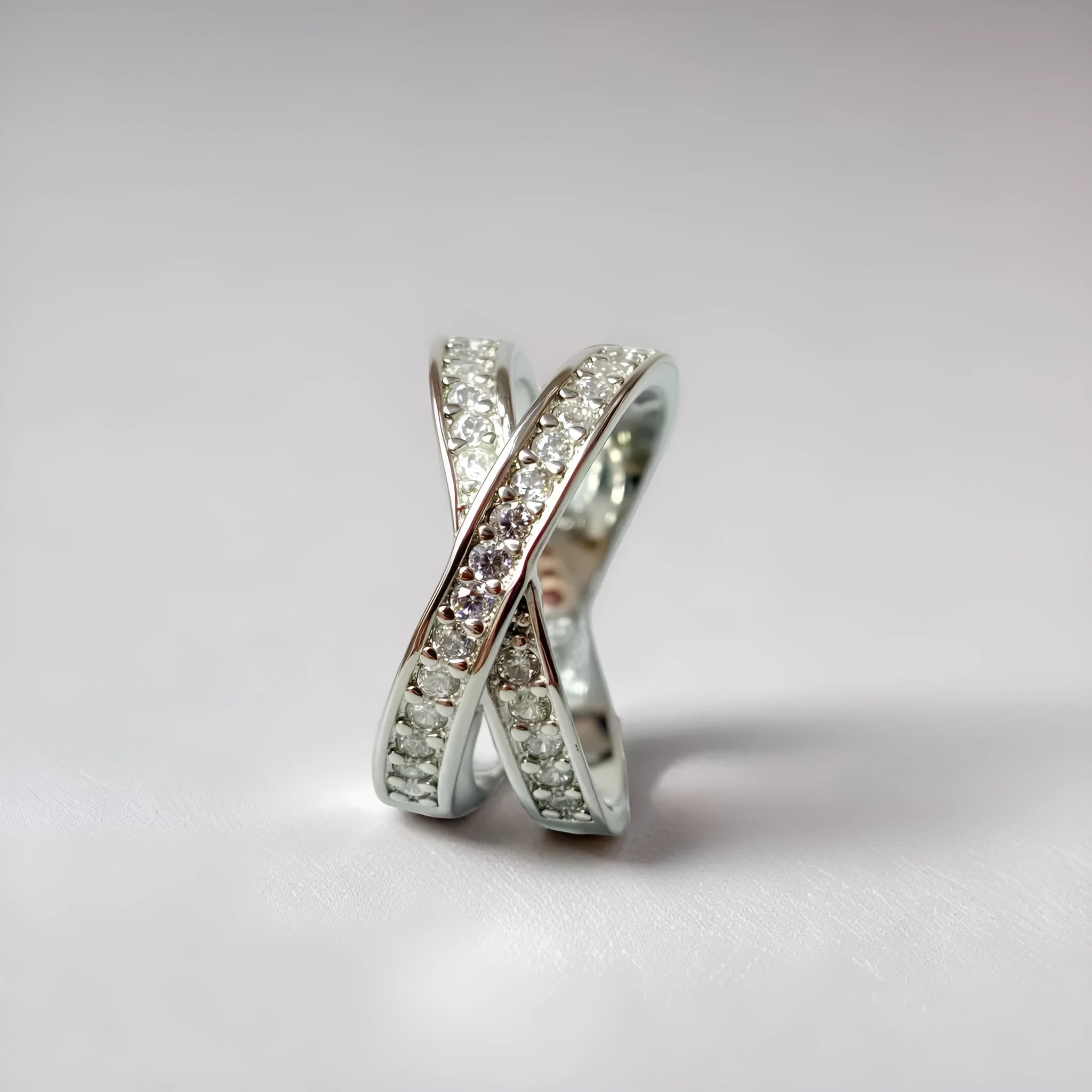 Metal cross ring with micro-inlaid zircon stones in silver or rose gold electroplate