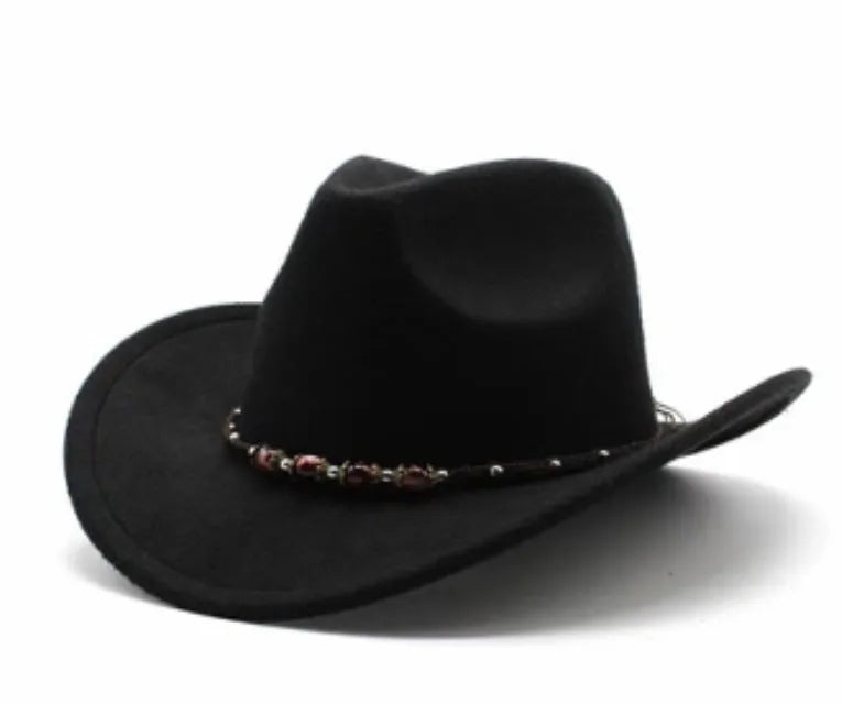 Brown leather velvet curved edge Western cowboy hat with a conical crown on a table.