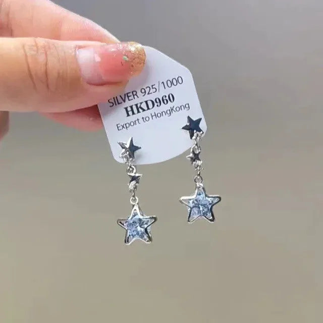 Gold heart-shaped geometric women's earrings with rhinestone stars and a tassel on the clip.