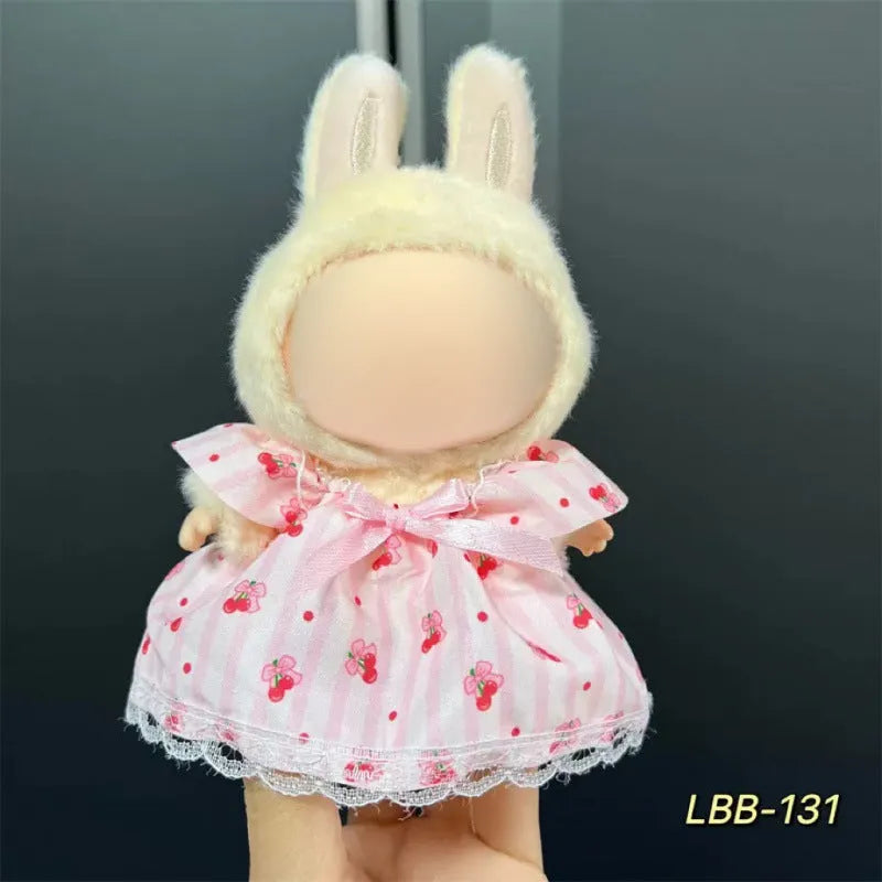 Plastic doll clothing costume for 17cm tall vinyl figurines on a display stand.