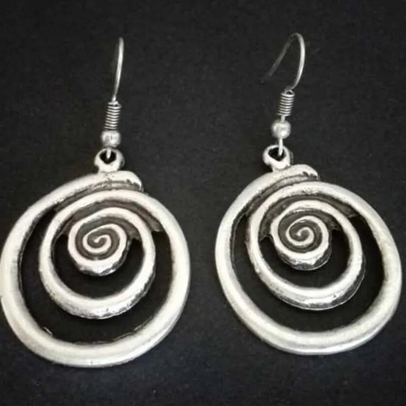 Geometric spiral distressed silver earrings measuring 2.6cm by 5cm with unisex design