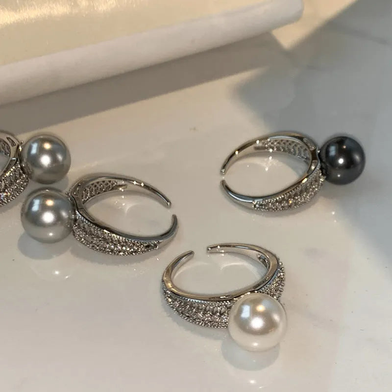 Geometric copper open band ring for women with a black pearl and adjustable opening.