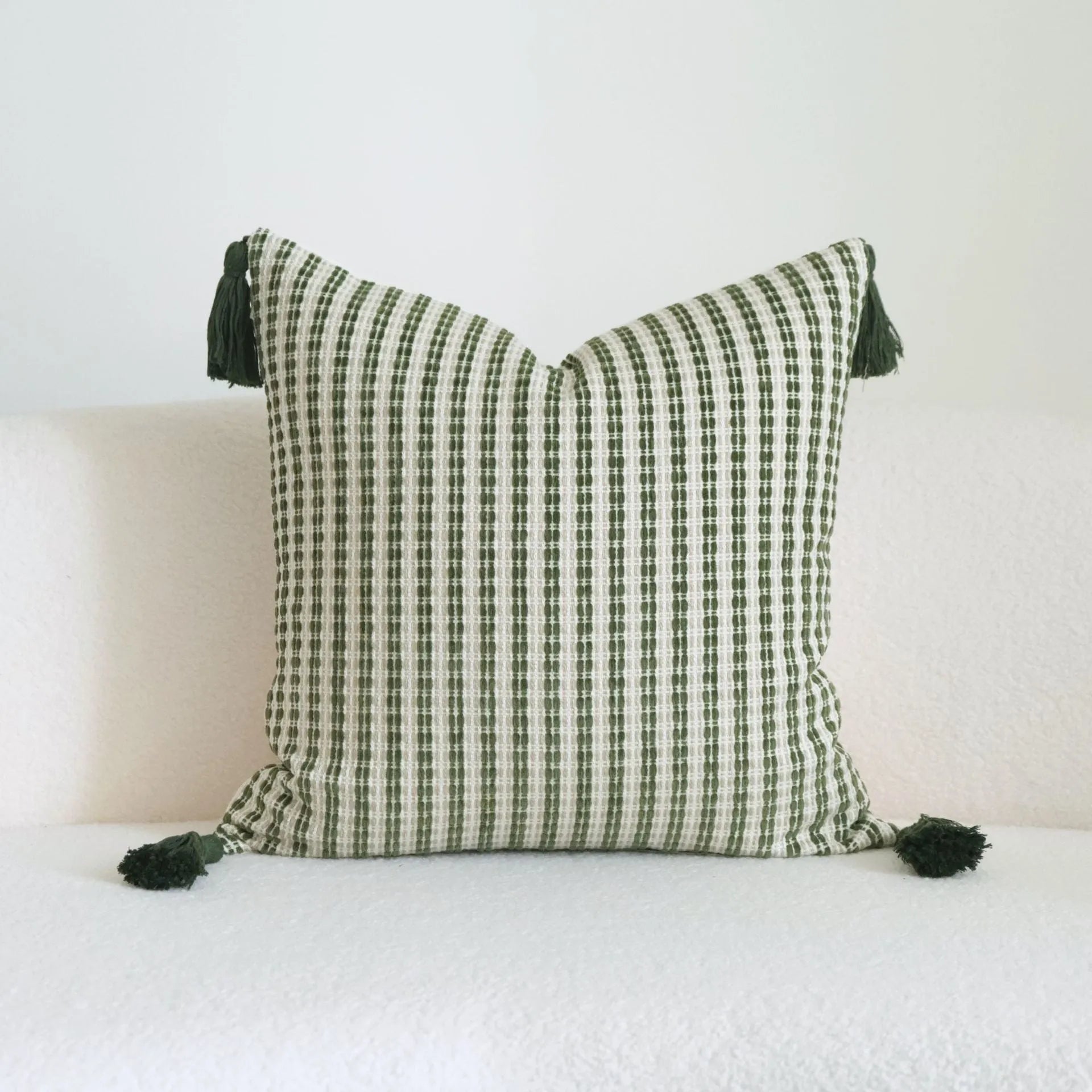 Green botanical patterned decorative pillows in striped, tree, and leaf designs on brushed cotton linen fabric