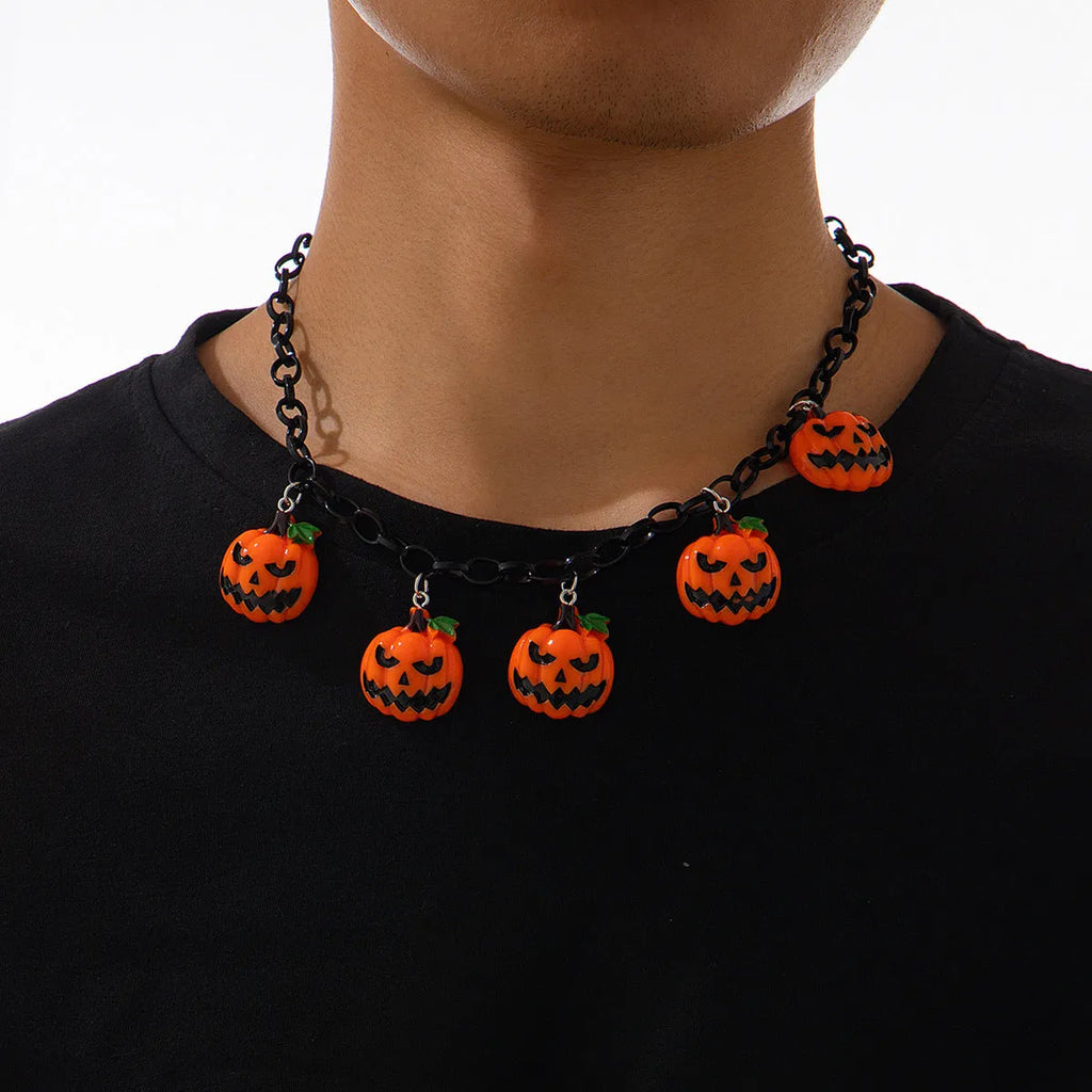 Halloween necklace with ghost and pumpkin cartoon pendants on a chain, in mixed colours.