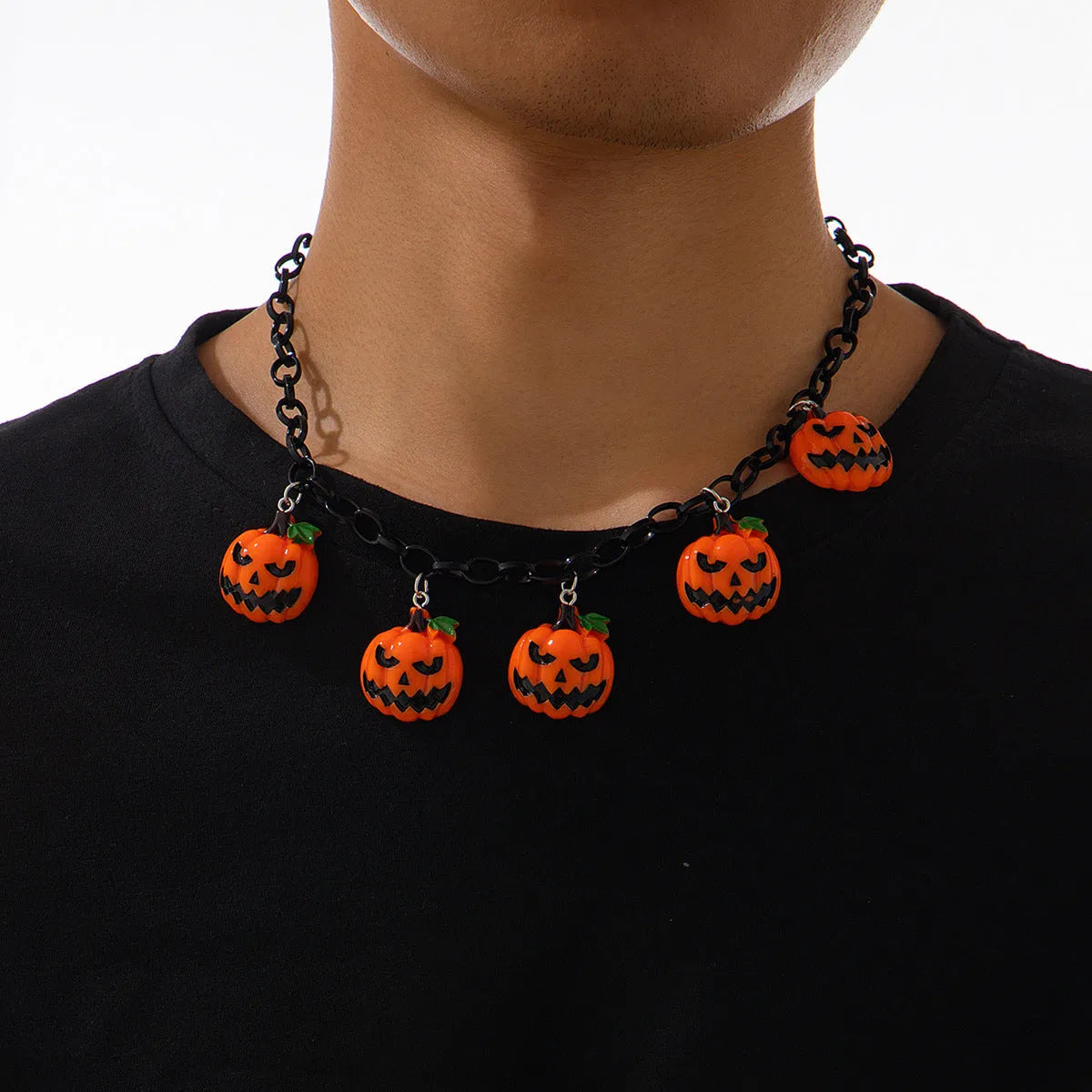 Halloween necklace with ghost and pumpkin cartoon pendants on a chain, in mixed colours.