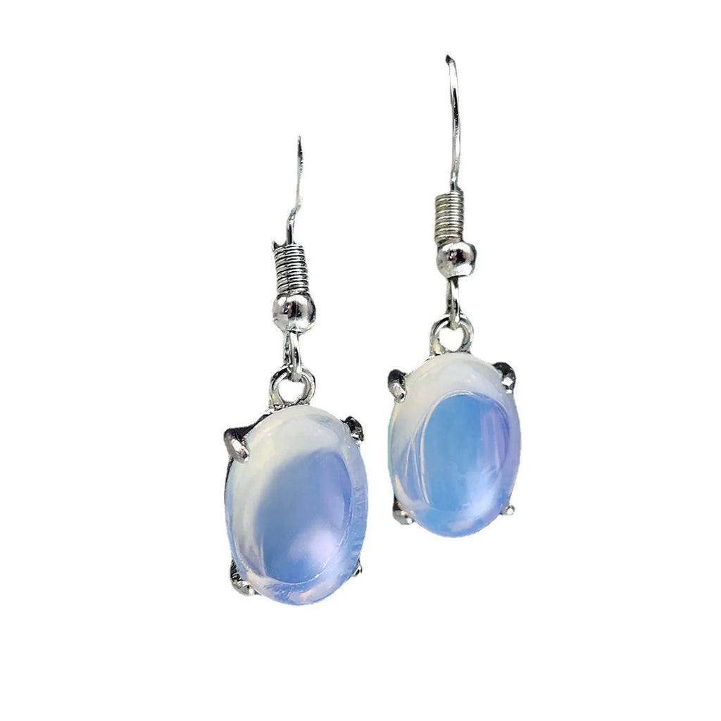 A pair of retro-style drop earrings with a moonlight opal colour and simple cross detail.
