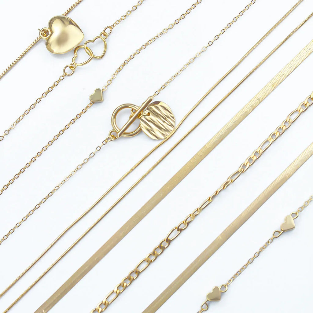 Ten gold necklaces with alloy pendants on adjustable snake bone chains in a women's jewellery set