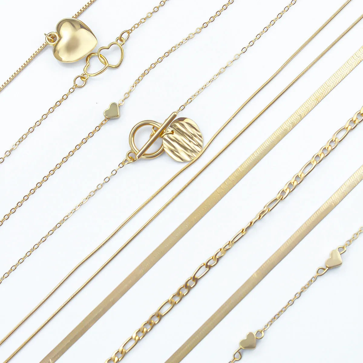 Ten gold necklaces with alloy pendants on adjustable snake bone chains in a women's jewellery set