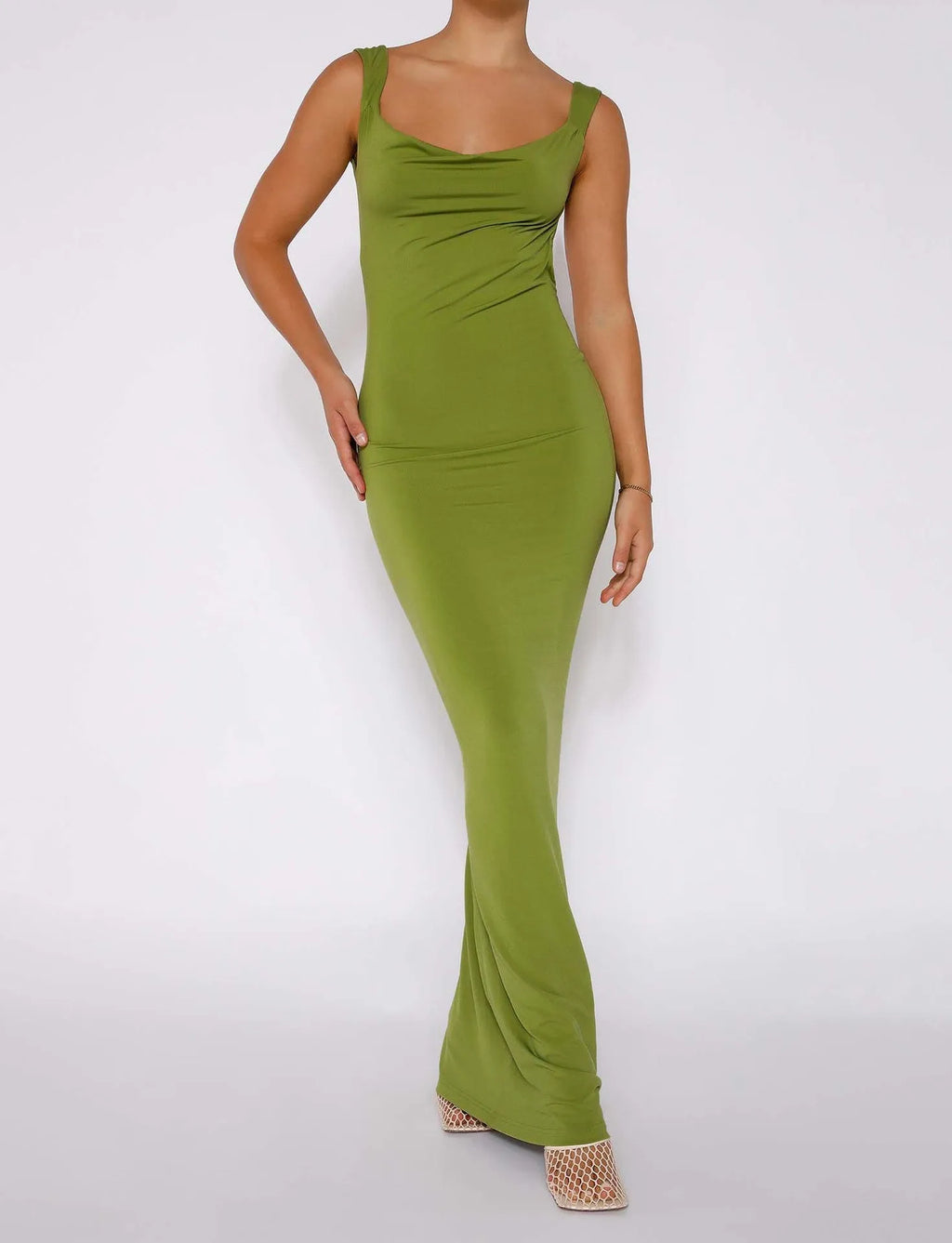 Champagne coloured backless slim fit dress with spaghetti straps and a hip-length skirt.