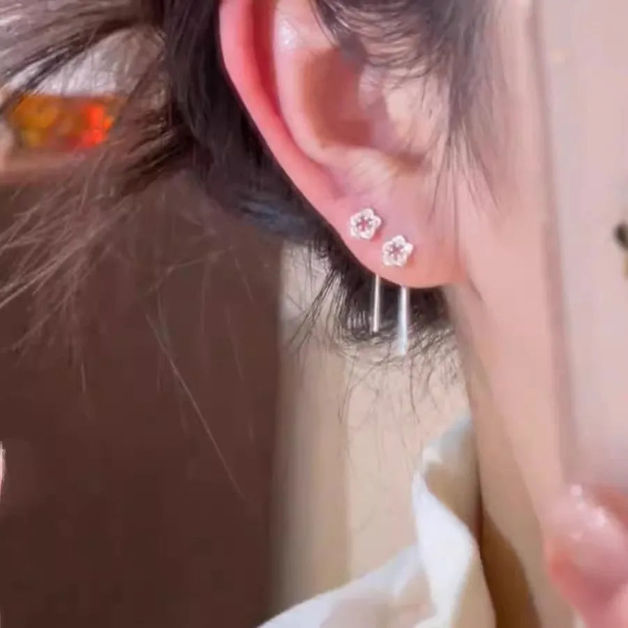 Sterling silver hollow flower hanging earrings with petal detailing and alloy construction