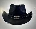 Brown leather velvet curved edge Western cowboy hat with a conical crown on a table.
