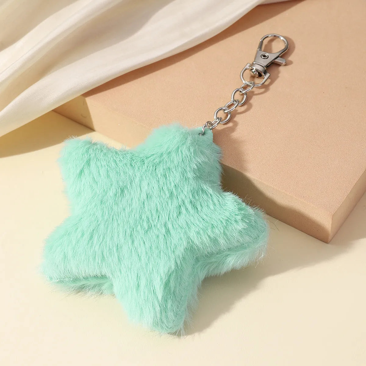 Zinc alloy five-pointed star plush key chain pendant in modern simple style, front view