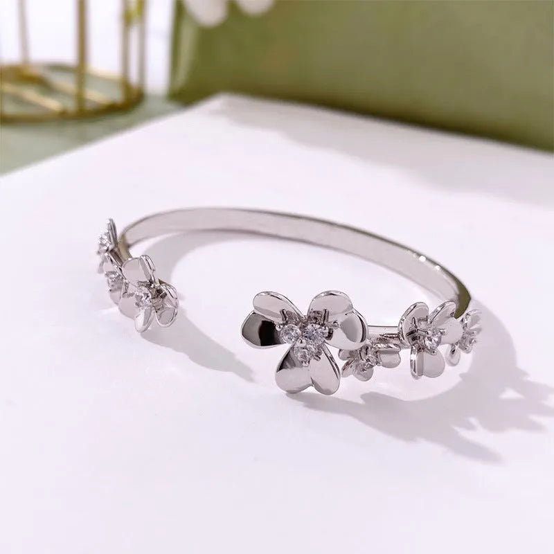 Three-leaf flower micro inlaid zircon bracelet in gold, rose gold, and silver colours on a copper base with electroplated finish.