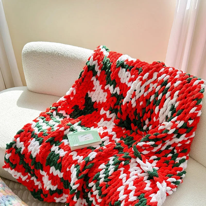 Handmade striped chenille winter blanket in caramel mango colour draped over a bed.