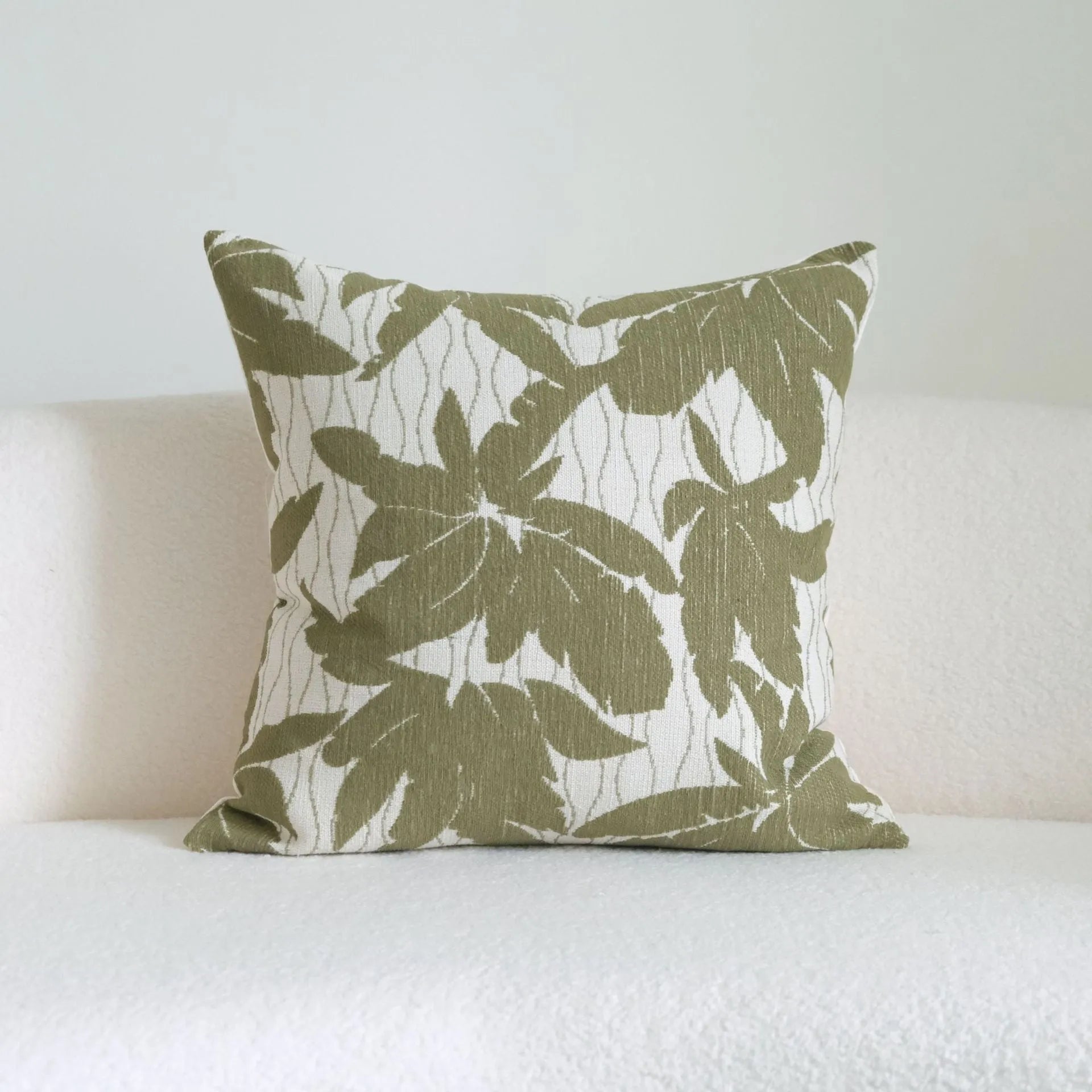 Green botanical patterned decorative pillows in striped, tree, and leaf designs on brushed cotton linen fabric