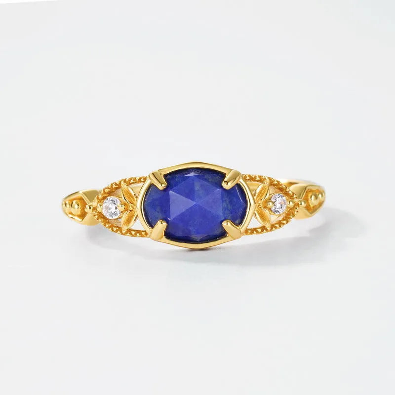 Japanese style silver alloy ring with a deep blue lapis lazuli stone in an elliptical geometric setting.