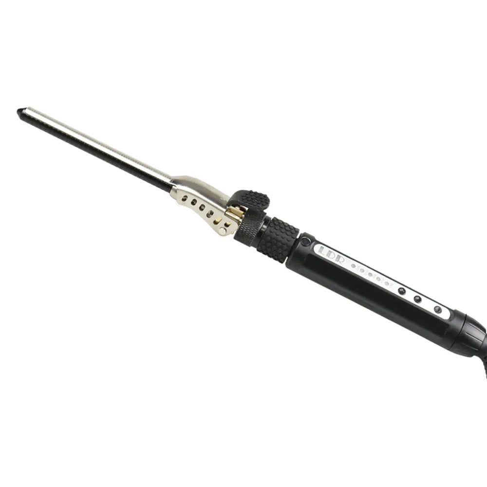 Black 7mm small hair curler with rotatable clip on a flat surface