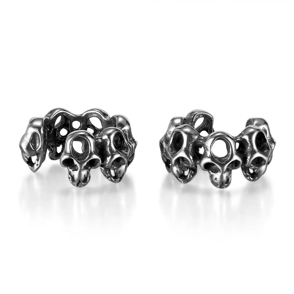 Stainless steel skull earrings with geometric hollow design and clip fitting in metallic finish