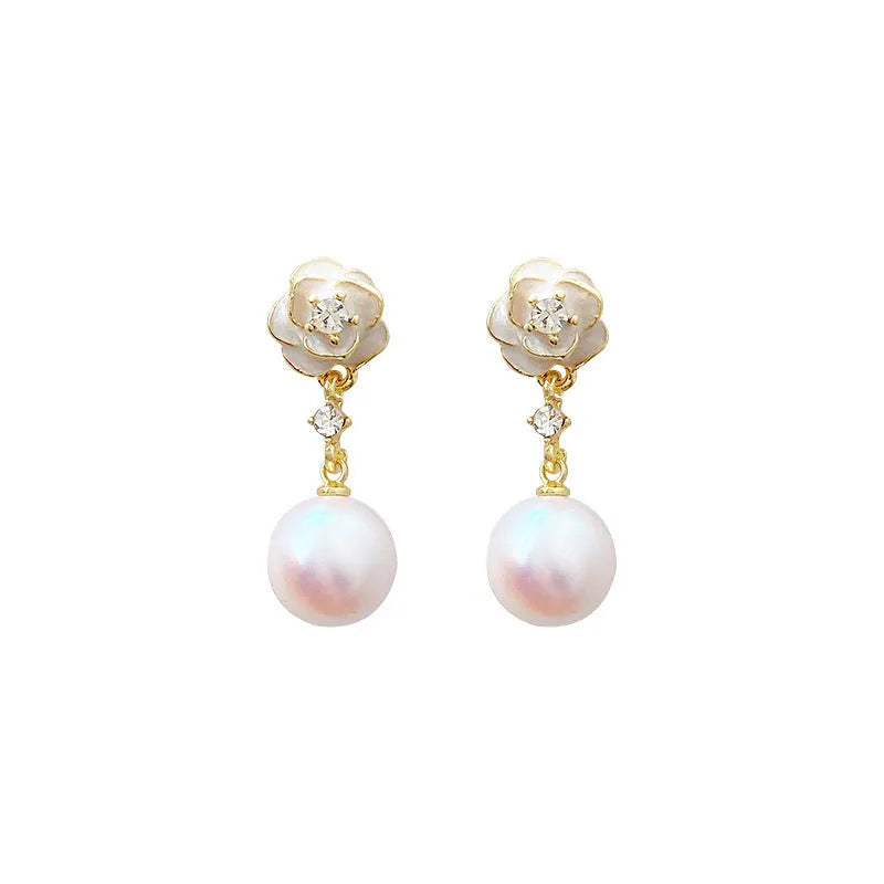 A pair of camellia flower-shaped alloy stud earrings for women on a white background.