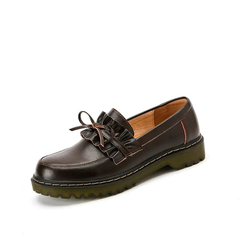 Women's black leather chunky heel shoes with a round toe on a neutral background.