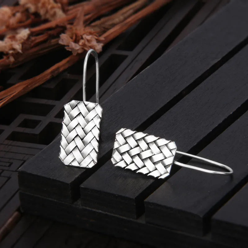 Geometric woven diamond plaid earrings in silver measuring 17.5mm by 11mm