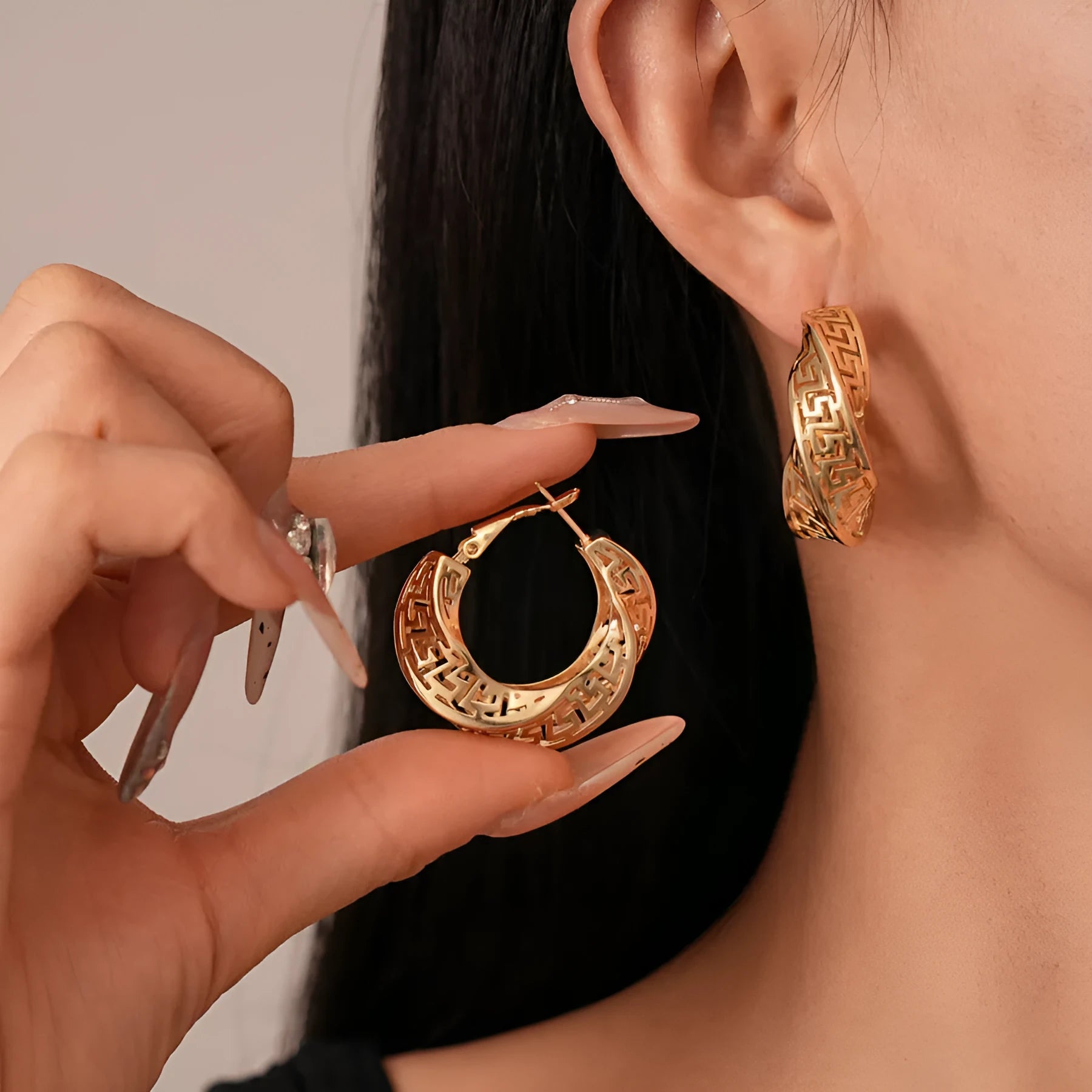Women's geometric hollow stud earrings with twisted round design in silver or gold electroplated copper