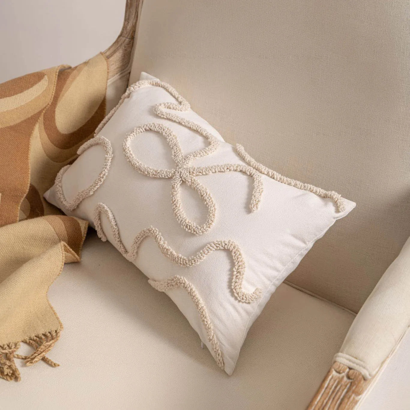 Knitted sofa cushion cover with tassel detail and striped pattern in spiral dots colour design