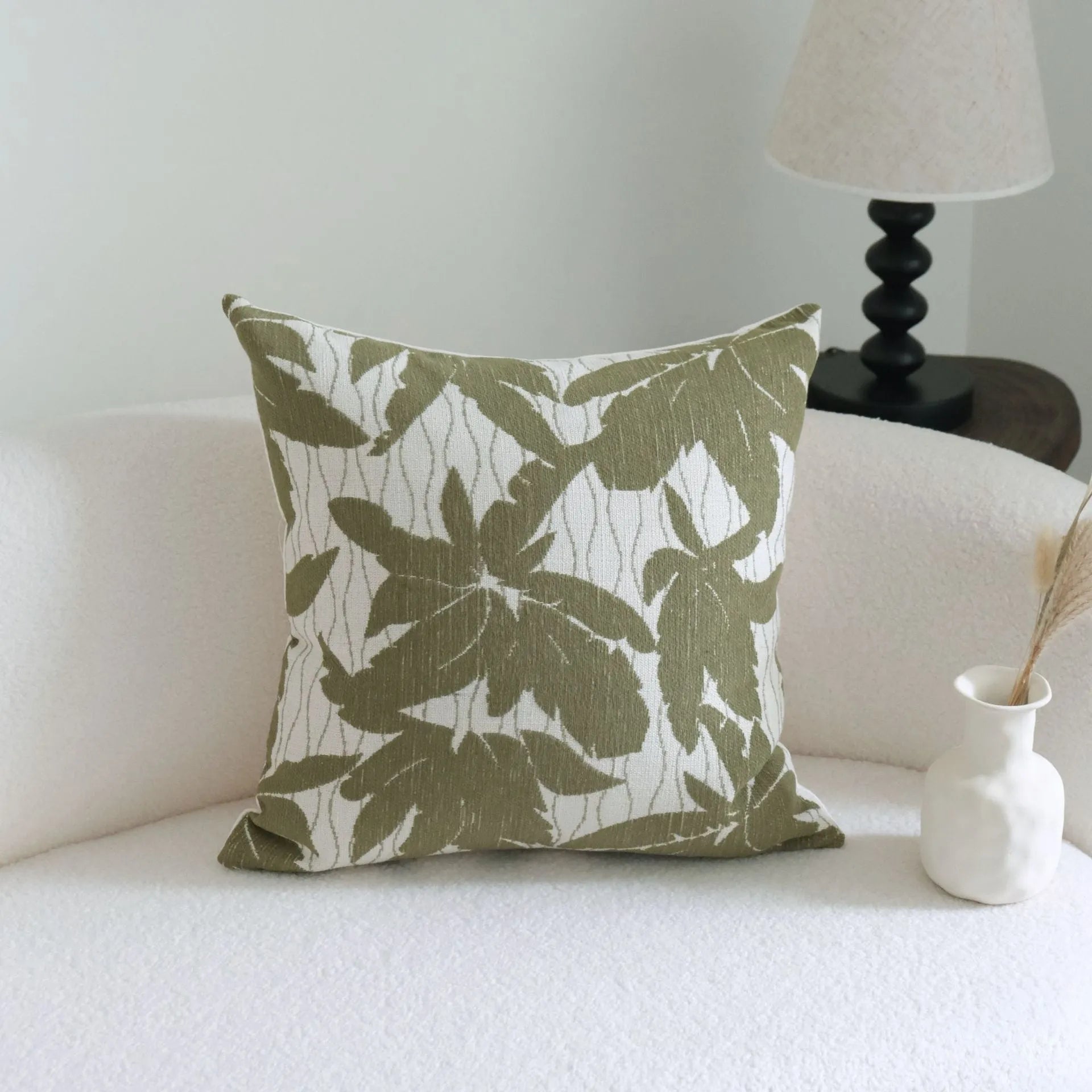 Green botanical patterned decorative pillows in striped, tree, and leaf designs on brushed cotton linen fabric