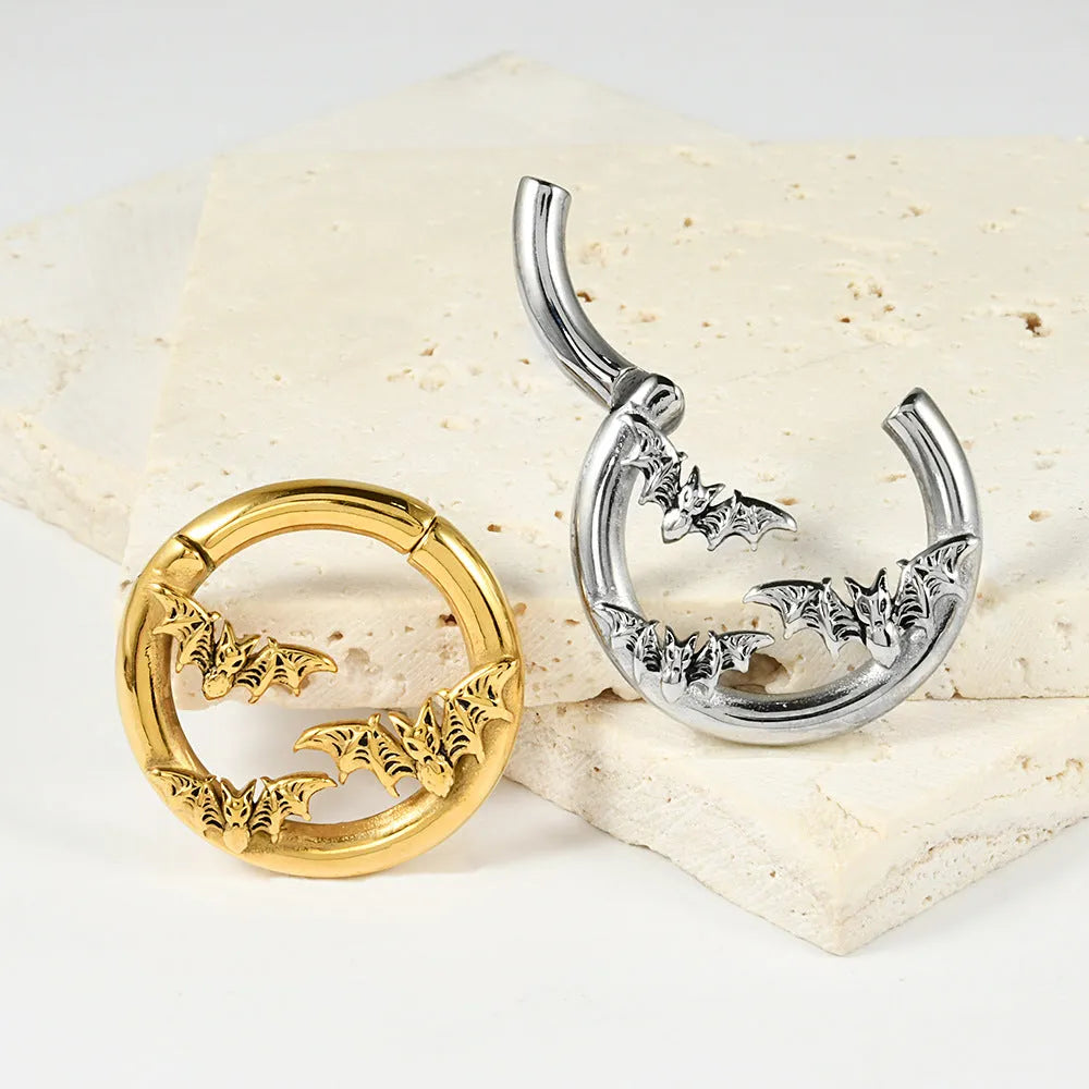 A pair of silver fashion earrings featuring a detailed totem pattern design on a stainless steel base.