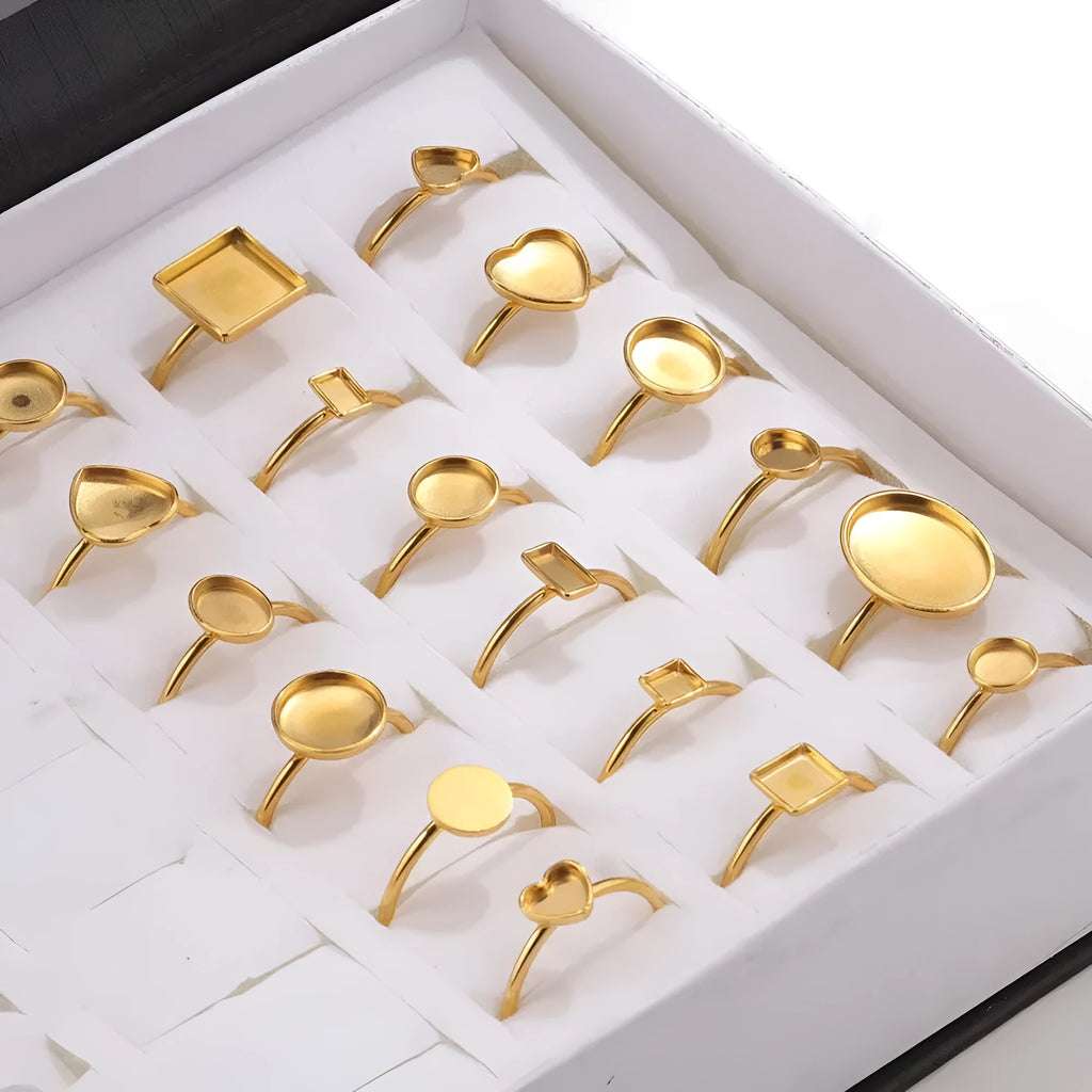 Assortment of golden electroplated stainless steel ring settings and DIY jewellery components in various shapes.
