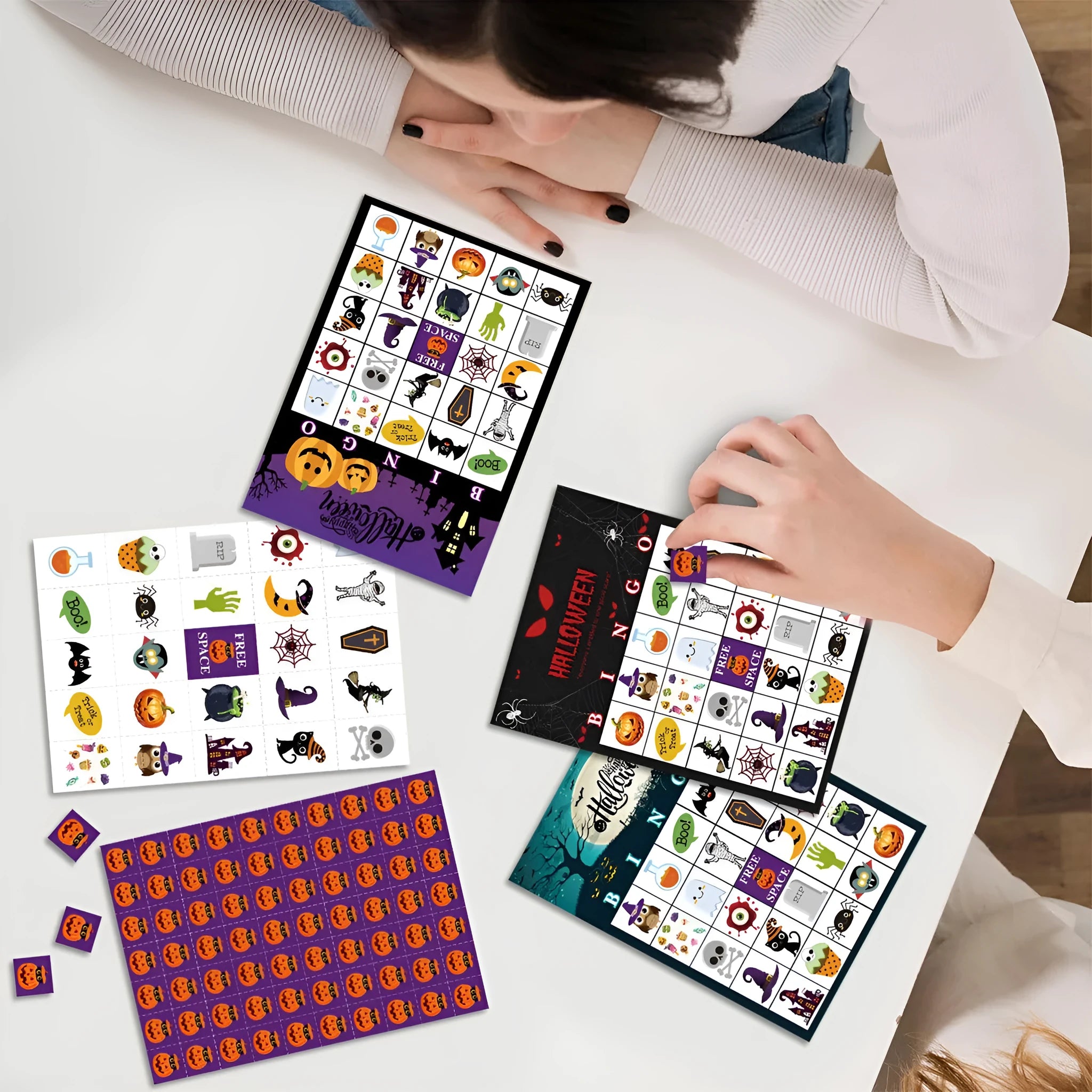 Halloween bingo game card with pumpkin design and paper nameplates on a table