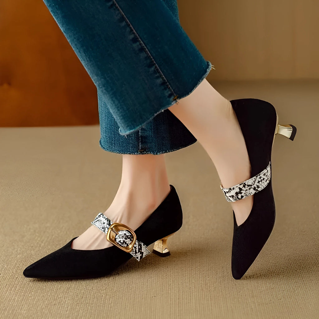 Women's black pointed toe stiletto high heels with a buckle strap on the instep