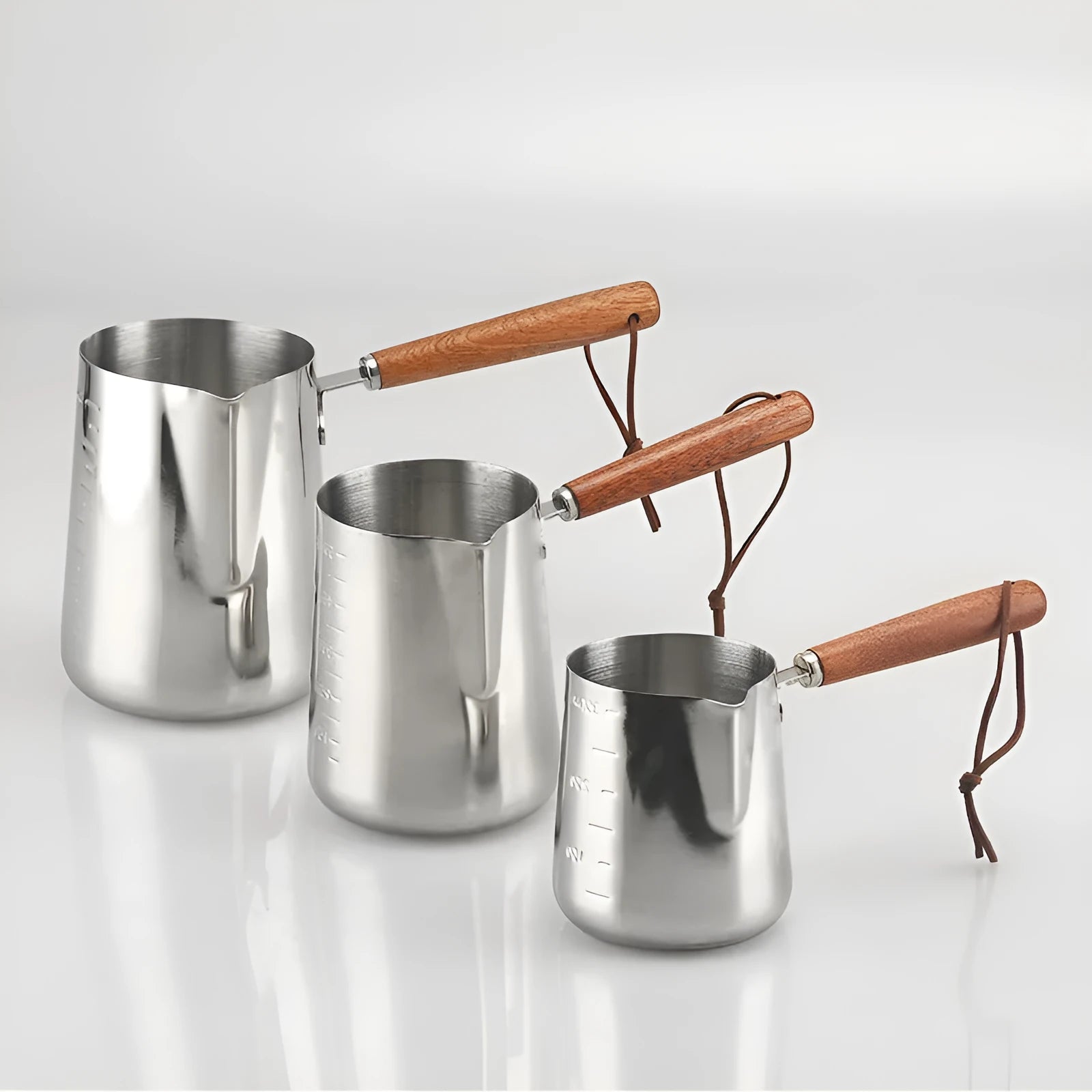 Stainless steel coffee cup with volume measurement scale and wooden handle in three capacity sizes