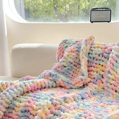 Handmade striped chenille winter blanket in caramel mango colour draped over a bed.