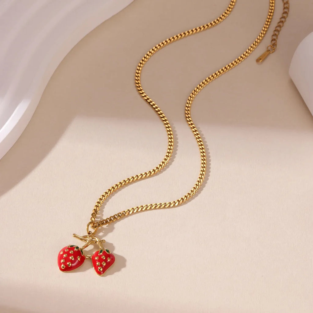 Stainless steel strawberry fruit pendant necklace on an alloy chain, shown in red and white colour options.