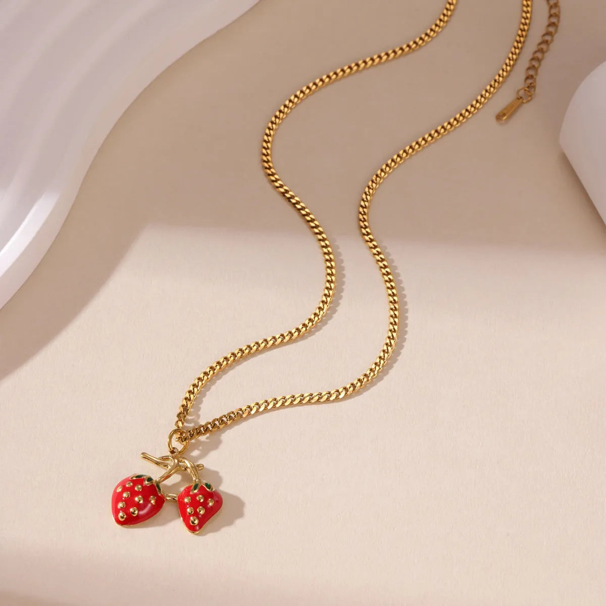 Stainless steel strawberry fruit pendant necklace on an alloy chain, shown in red and white colour options.