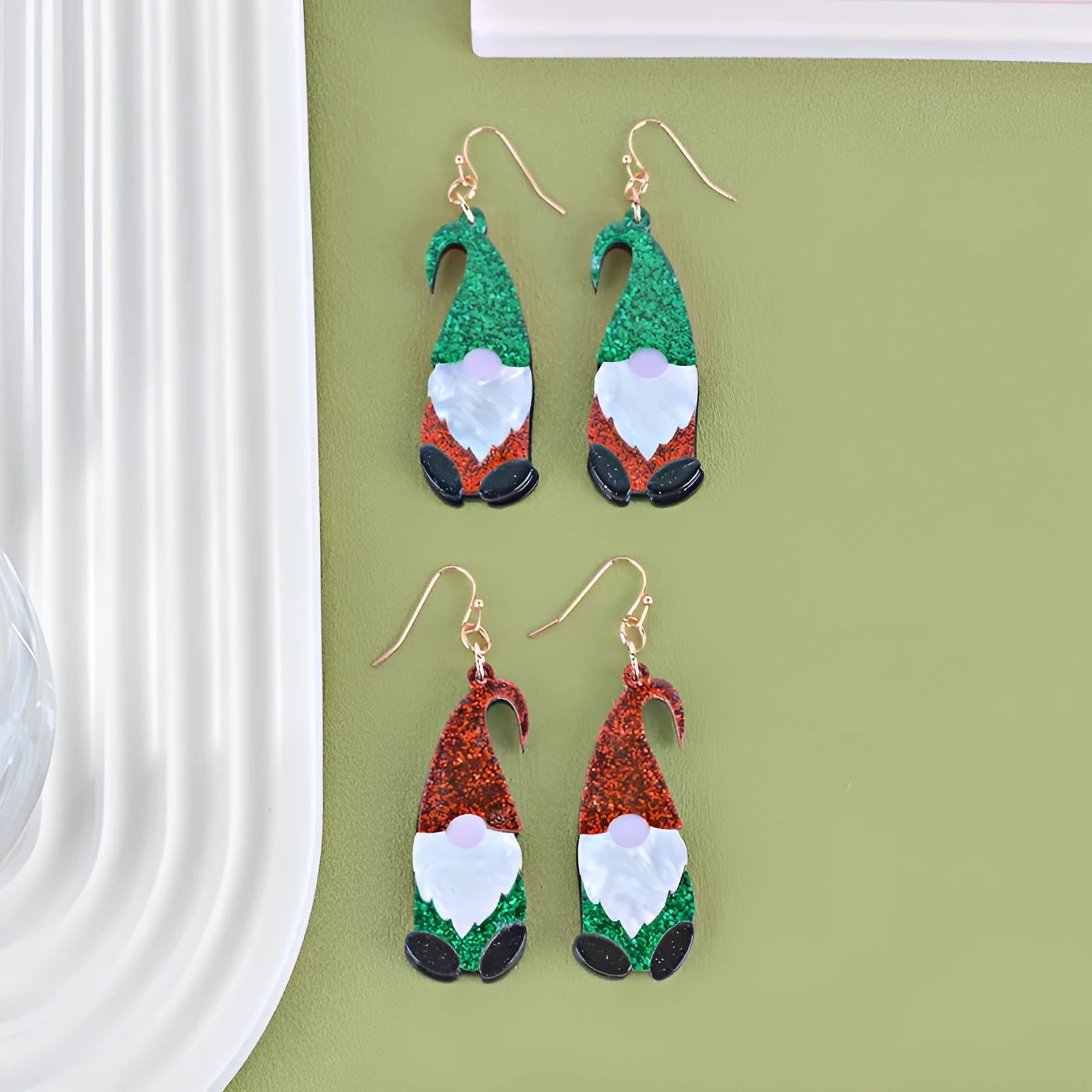 Pair of cartoon Santa Claus acrylic earrings in red and green hat style.