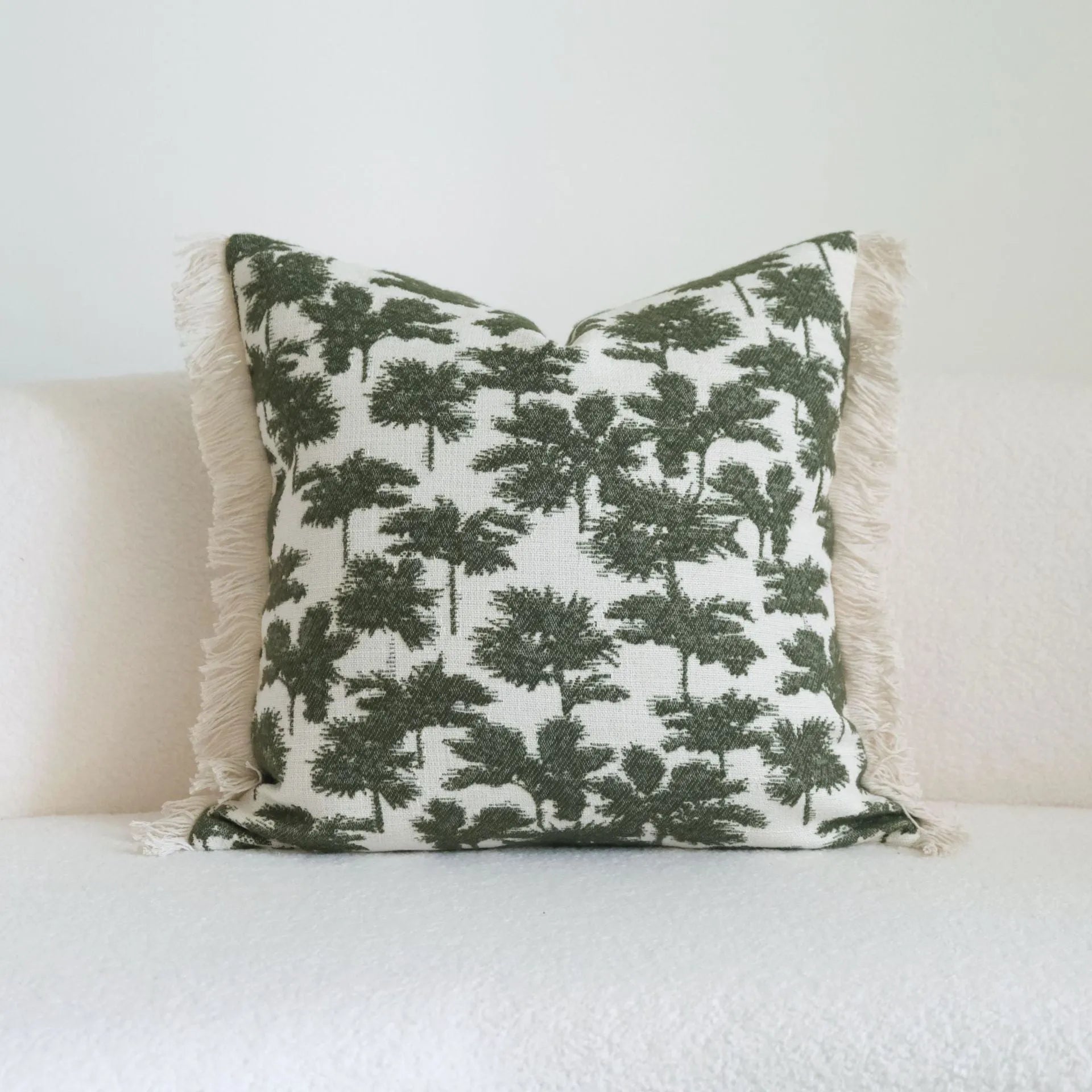 Green botanical patterned decorative pillows in striped, tree, and leaf designs on brushed cotton linen fabric