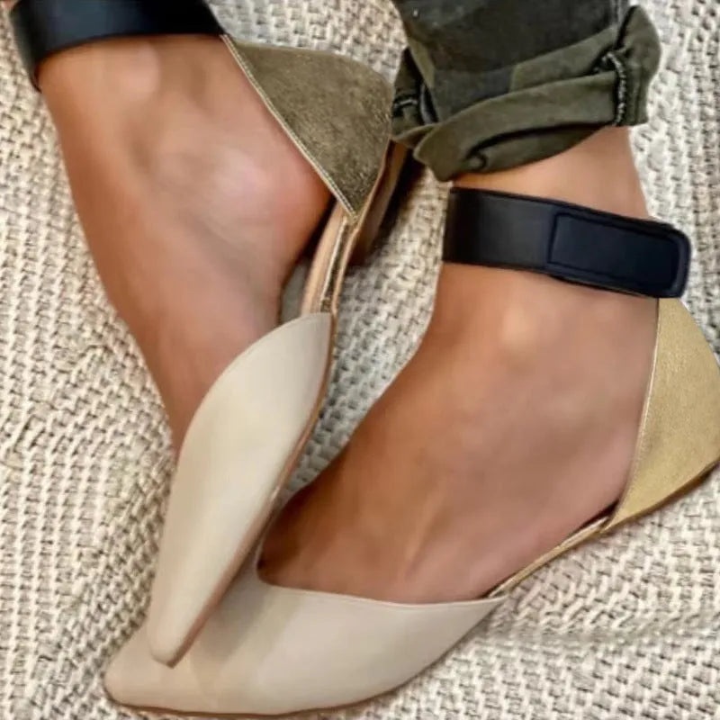 Women's beige casual sandals with Velcro straps and a hollowed flat sole on a light background.