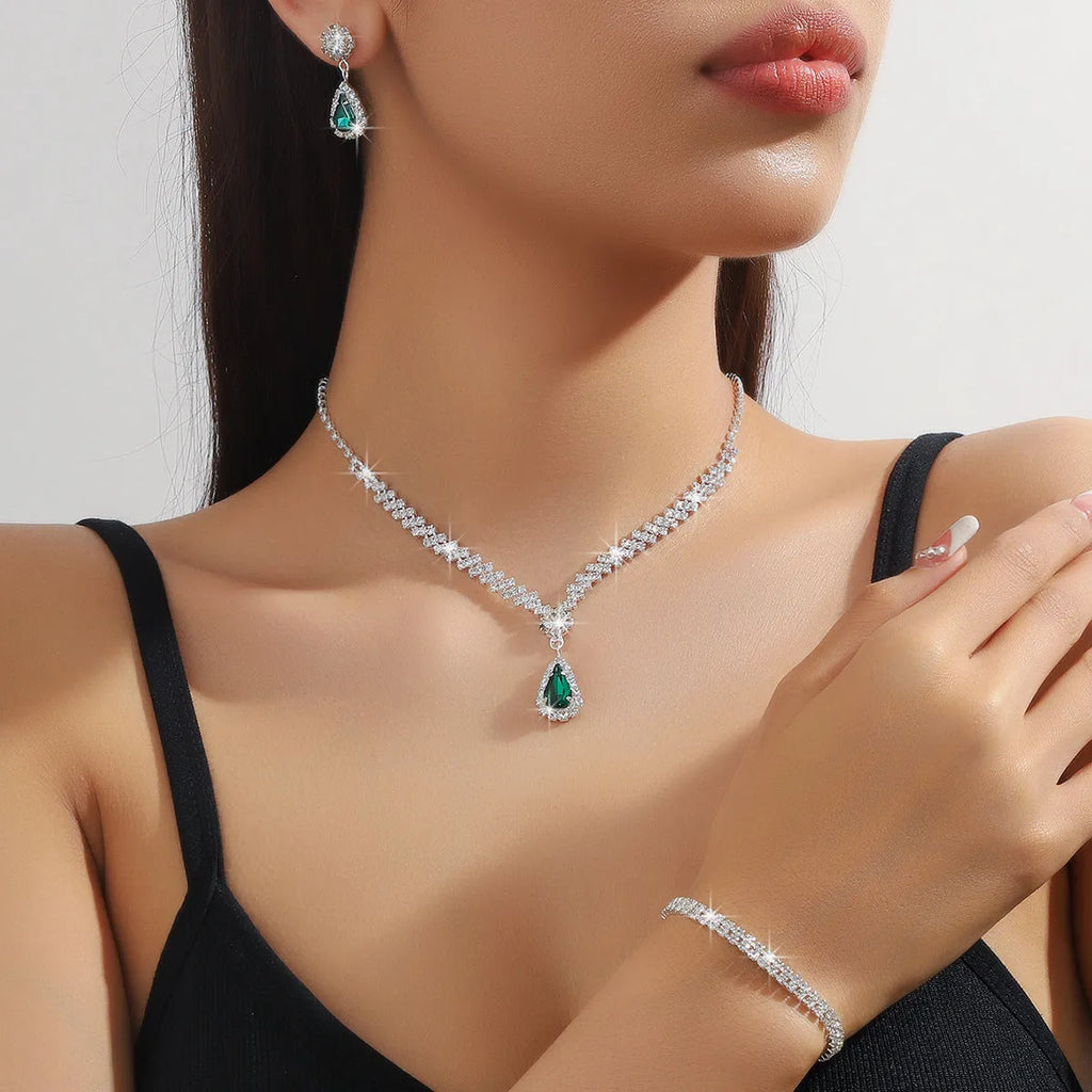 Claw chain necklace and matching earrings set with drop-shaped rhinestones in multiple colour options