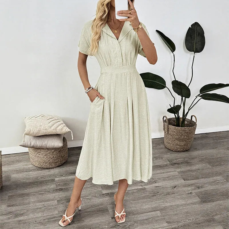 Light green women's shirtdress with lapel collar, waist tie, and side pockets.