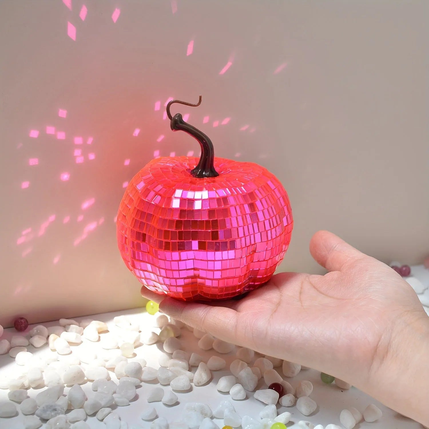 Chinese-style mirror glass pumpkin Halloween decoration in various sizes on a shelf.