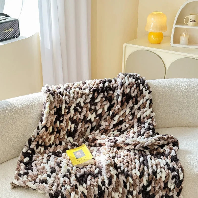 Handmade striped chenille winter blanket in caramel mango colour draped over a bed.