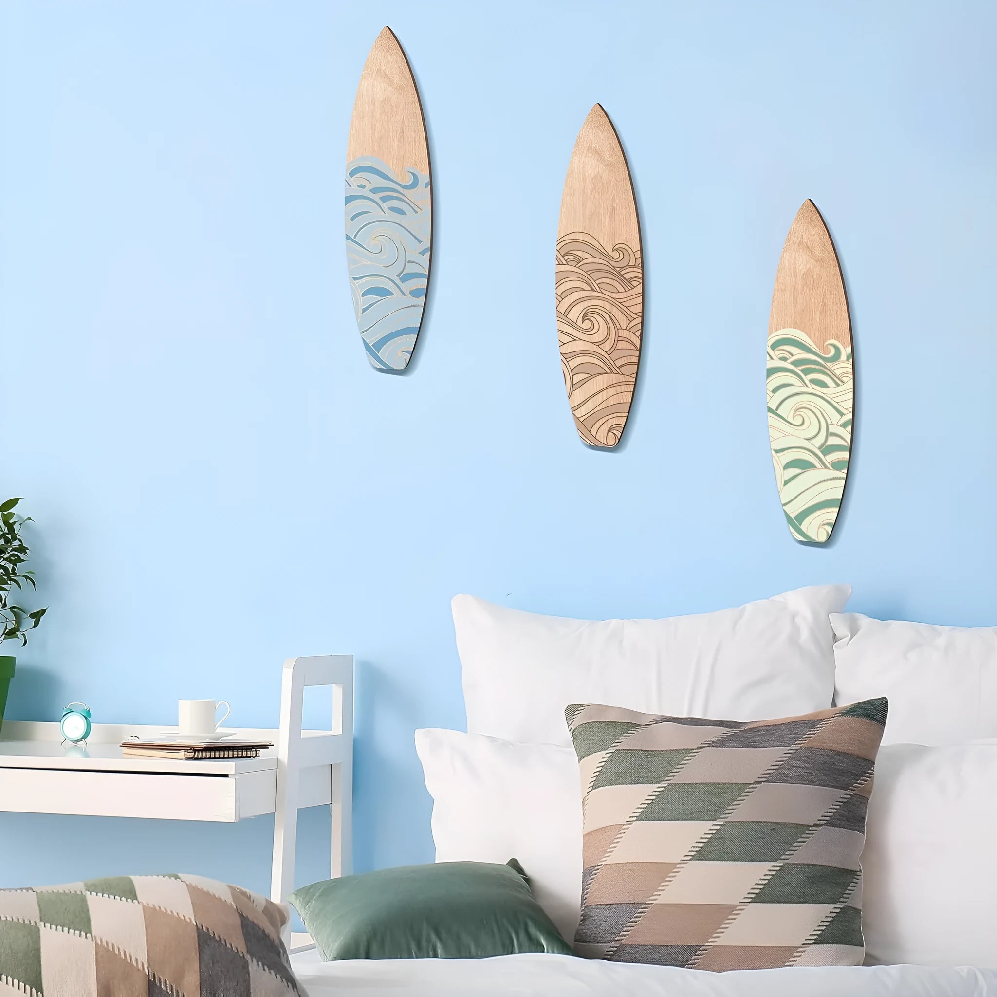 Three wooden surfboard-shaped wall decorations displayed together