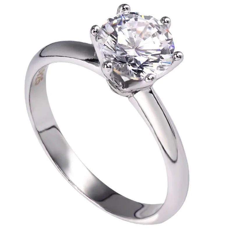 White gold plated copper ring with six-claw set zircon stone, geometric shape.