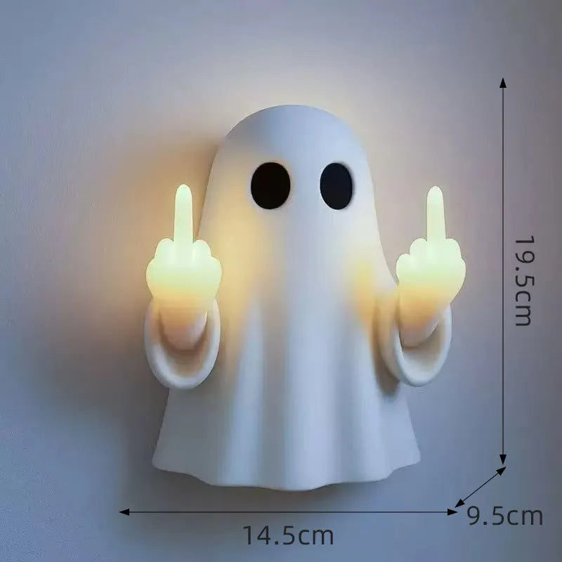 Small white modern ghost statue night light for Halloween decoration on a table.