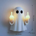 Small white modern ghost statue night light for Halloween decoration on a table.